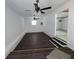 Inviting living room featuring dark wood-look flooring, ceiling fans, and a bright, airy ambiance at 1201 E Gimber St, Indianapolis, IN 46203