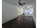 Inviting living room featuring dark wood-look flooring, ceiling fans, and a bright, airy ambiance at 1201 E Gimber St, Indianapolis, IN 46203