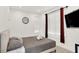 Bedroom with a large bed, neutral decor, and a wall-mounted TV at 1405 E Vermont St, Indianapolis, IN 46201