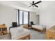 Bright bedroom featuring twin beds, modern ceiling fan and light gray flooring at 1405 E Vermont St, Indianapolis, IN 46201