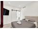 Cozy bedroom with a gray bed, a barn door, and natural light at 1405 E Vermont St, Indianapolis, IN 46201