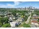Panoramic aerial view capturing a neighborhood with lush greenery and the downtown city skyline, showcasing urban living at 1405 E Vermont St, Indianapolis, IN 46201
