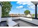 Outdoor deck with white seating, a gray rug, string lights, and a view of the neighborhood at 1405 E Vermont St, Indianapolis, IN 46201