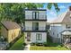 Modern three-story home with black trim, balconies, and tidy landscaping showcases curb appeal at 1405 E Vermont St, Indianapolis, IN 46201