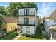 Modern three-story home with black trim, balconies, and tidy landscaping displays city appeal at 1405 E Vermont St, Indianapolis, IN 46201