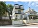 Modern three-story home with white siding, black trim, and a double-balcony facade offers stylish curb appeal at 1405 E Vermont St, Indianapolis, IN 46201