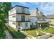 Modern three-story home with black trim, balconies, and tidy landscaping in a desirable location at 1405 E Vermont St, Indianapolis, IN 46201