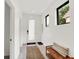 Bright foyer featuring a full glass door, bench seat and light gray flooring, creating a welcoming entrance at 1405 E Vermont St, Indianapolis, IN 46201