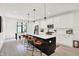 Modern kitchen featuring a large island with seating, white cabinets, and stainless steel appliances for style and function at 1405 E Vermont St, Indianapolis, IN 46201