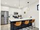 Modern kitchen features stainless appliances, white cabinets and countertops, and pendant lighting at 1405 E Vermont St, Indianapolis, IN 46201