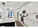 Contemporary kitchen featuring stainless steel appliances, a kitchen island, and white cabinetry at 1405 E Vermont St, Indianapolis, IN 46201