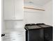 Bright laundry room with sleek, new, black washer and dryer, cabinets, and countertop at 1405 E Vermont St, Indianapolis, IN 46201