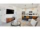Open-concept living room showcasing a kitchen island, modern furnishings, and a view of the bedroom at 1405 E Vermont St, Indianapolis, IN 46201