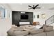 Comfortable living room with dark accent wall, media console, and gray sectional offers a stylish space at 1405 E Vermont St, Indianapolis, IN 46201