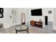 Well-lit living room with stylish decor and a view into the bathroom and backyard at 1405 E Vermont St, Indianapolis, IN 46201