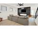 Comfortable living room with dark accent wall, media console, and gray sectional offers a stylish space at 1405 E Vermont St, Indianapolis, IN 46201