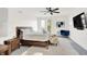 Spacious main bedroom featuring a king bed, soft rug, TV, and cozy blue chair at 1405 E Vermont St, Indianapolis, IN 46201