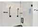 Modern shower with white subway tile, black fixtures, glass doors, and a sleek design at 1405 E Vermont St, Indianapolis, IN 46201