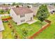 Aerial view of a fenced backyard with a patio and garden, surrounded by lush greenery and neighborhood homes at 1449 Danielle Dr, Indianapolis, IN 46231