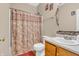 Bathroom with patterned shower curtain, wood cabinet and sink at 1449 Danielle Dr, Indianapolis, IN 46231