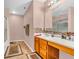 Well-lit bathroom with a mosaic tile backsplash and wood cabinetry at 1449 Danielle Dr, Indianapolis, IN 46231