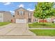 Attractive two-story brick home with a well-manicured lawn and attached garage at 1449 Danielle Dr, Indianapolis, IN 46231