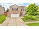 Traditional two-story brick home with a well-manicured lawn, mature trees, and an attached two-car garage at 1449 Danielle Dr, Indianapolis, IN 46231