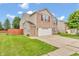 Charming two-story home with a brick and vinyl exterior, a two-car garage, and a green, well-kept lawn at 1449 Danielle Dr, Indianapolis, IN 46231