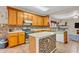 A well-lit kitchen includes an island, wooden cabinets, and modern appliances at 1449 Danielle Dr, Indianapolis, IN 46231