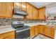 Well-maintained kitchen featuring wooden cabinets, neutral countertops and stainless steel appliances at 1449 Danielle Dr, Indianapolis, IN 46231