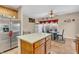 Kitchen with stainless steel refrigerator, island with light countertop and tiled backsplash at 1449 Danielle Dr, Indianapolis, IN 46231