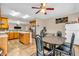 Open-concept kitchen with tile floors, an island, appliances, and dining table with chairs at 1449 Danielle Dr, Indianapolis, IN 46231