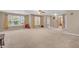Spacious carpeted living room featuring neutral walls and large windows at 1449 Danielle Dr, Indianapolis, IN 46231