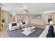 A bright and airy living room, virtually staged, with couches and carpet flooring at 1449 Danielle Dr, Indianapolis, IN 46231