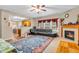 Inviting living space featuring a fireplace, large sofa, and open access to the kitchen with bar seating at 1449 Danielle Dr, Indianapolis, IN 46231