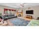 Comfortable living room with a fireplace, a large leather sofa, and a flat-screen TV above a wooden table at 1449 Danielle Dr, Indianapolis, IN 46231