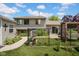 Fenced backyard features a patio, lush landscaping, and a walkway leading to the side of the house at 1481 Wrenwood Dr, Columbus, IN 47201