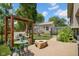 Inviting backyard featuring a patio area, lush greenery, wooden pergola, and a fire pit perfect for outdoor entertaining at 1481 Wrenwood Dr, Columbus, IN 47201
