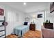 Cozy bedroom with wood floors, a small window, and a vintage lamp on a nightstand at 1481 Wrenwood Dr, Columbus, IN 47201