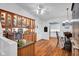 Cozy dining area with built-in cabinets, hardwood floors, and a view into the adjacent kitchen at 1481 Wrenwood Dr, Columbus, IN 47201