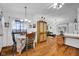 Inviting dining area with hardwood flooring, elegant chandelier, and view into the living room at 1481 Wrenwood Dr, Columbus, IN 47201