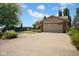 Spacious three-car garage with brick accents and ample parking on a wide concrete driveway at 1481 Wrenwood Dr, Columbus, IN 47201