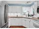 Modern kitchen featuring white cabinets, stainless steel appliances, and a bright window at 1481 Wrenwood Dr, Columbus, IN 47201