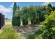 Landscaped yard featuring a rock garden, mature trees, and lush greenery, enhancing the outdoor appeal at 1481 Wrenwood Dr, Columbus, IN 47201