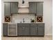 Basement bar area featuring dark cabinets, wine rack, granite countertop, and beverage refrigerator at 15600 Woodford Dr, Westfield, IN 46074