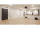 Finished basement with media screen and a dry bar area connecting to a stairway and hallway at 15600 Woodford Dr, Westfield, IN 46074