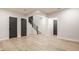 Open basement area with hardwood floors, neutral walls, and stairway leading to the upper level at 15600 Woodford Dr, Westfield, IN 46074