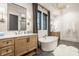 Bathroom with freestanding tub, tile floors, double vanities, modern fixtures, and a chandelier at 15600 Woodford Dr, Westfield, IN 46074