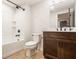Modern bathroom features a shower-tub combo, dark fixtures, and wood-finished vanity at 15600 Woodford Dr, Westfield, IN 46074