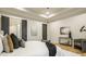 Spacious bedroom with hardwood floors, a console table with decor, and a soft upholstered chair at 15600 Woodford Dr, Westfield, IN 46074